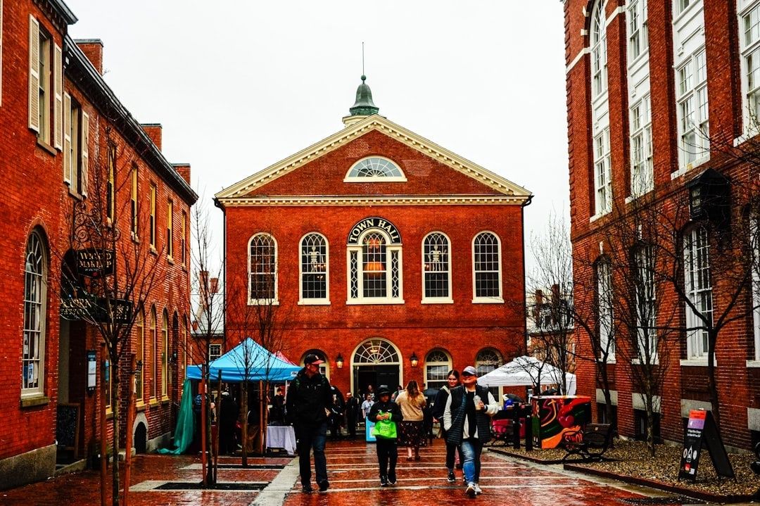 Residents gather outside a brick town hall during a community event