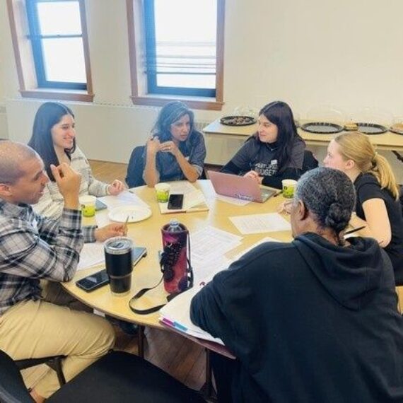 Residents discuss community decisions around a table at a meeting