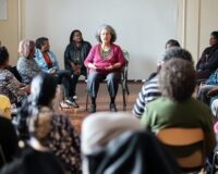 Diverse group seated in a circle during a community discussion